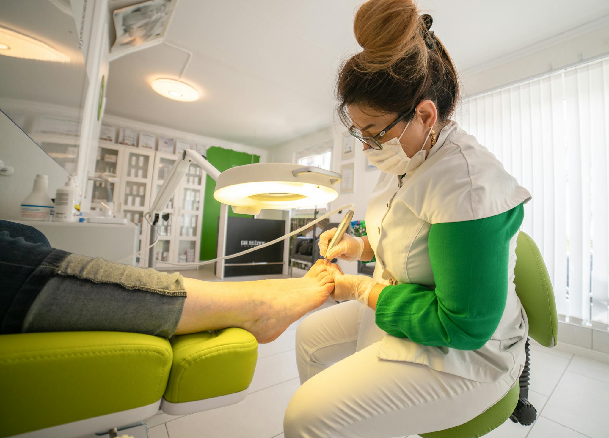 A skilled specialist performs a pedicure in a modern salon, showcasing hygiene and expertise.